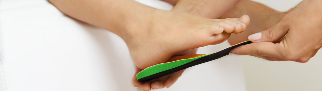 Orthotics being placed on a foot